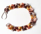 Bracelet with interlocking metal links in gold, silver, and bronze on a white background kids 5"