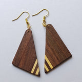 Wooden triangle earrings with gold accents on a light gray background